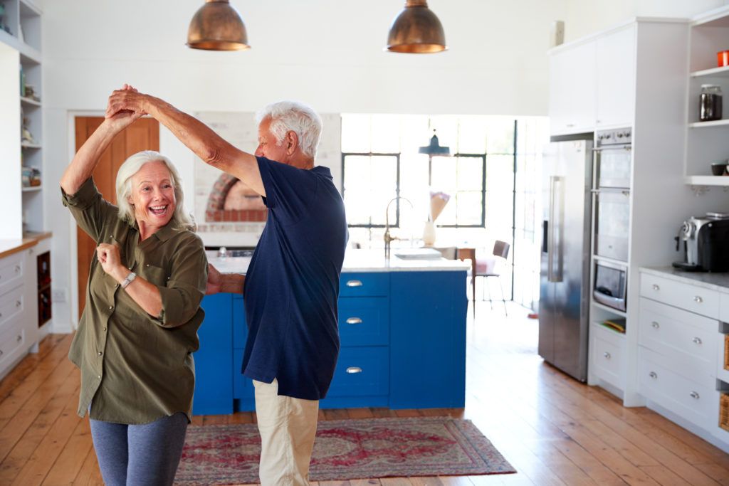 Ett äldre par som dansar i köket